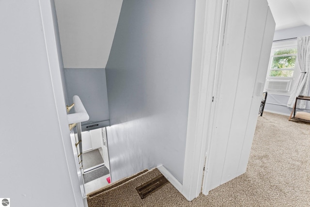 stairs featuring cooling unit and carpet floors