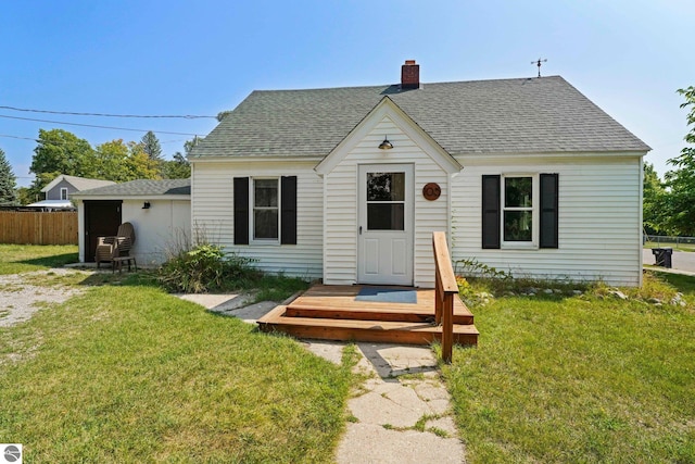 bungalow-style home with a wooden deck and a front lawn