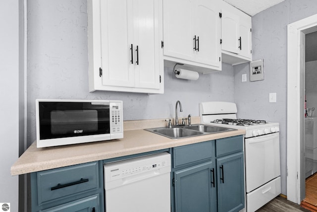 kitchen with sink, white appliances, dark hardwood / wood-style flooring, and white cabinets