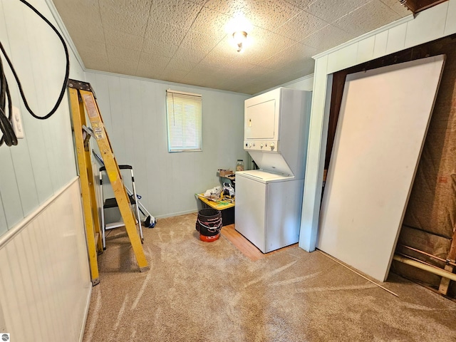 washroom with carpet flooring, stacked washer and dryer, and wooden walls