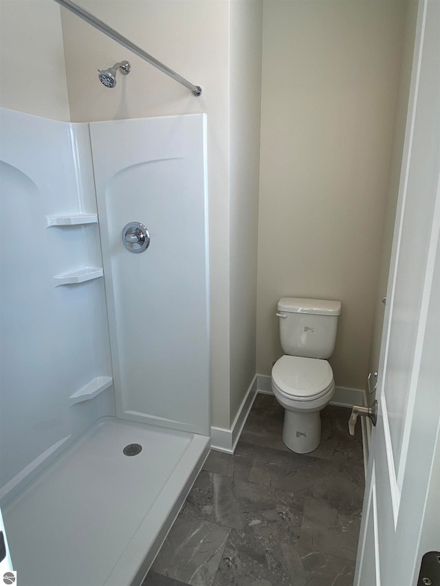 bathroom with toilet and a shower