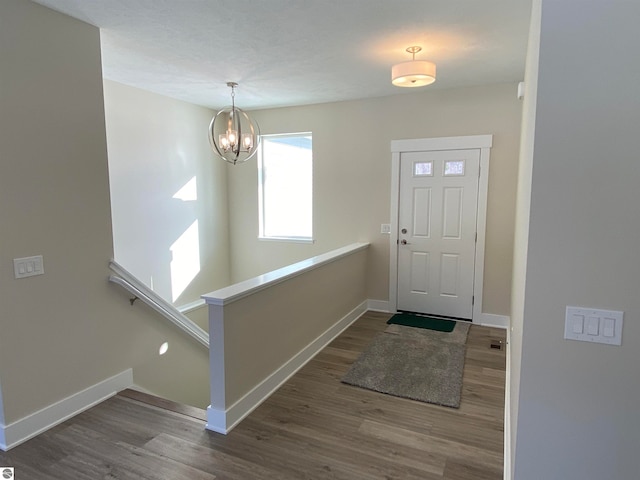 entryway featuring a notable chandelier and wood-type flooring