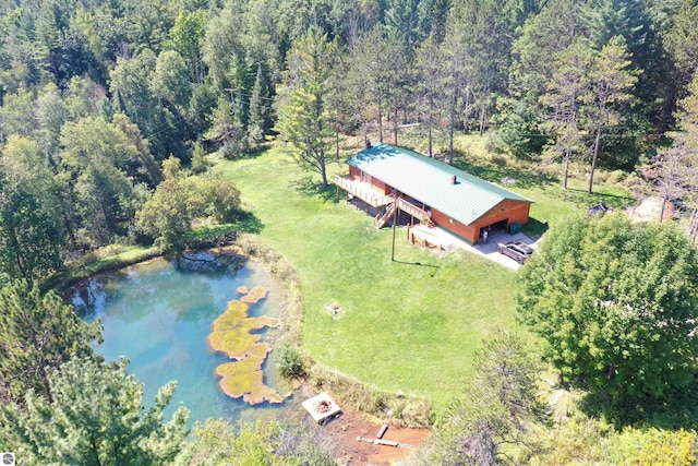 bird's eye view with a wooded view