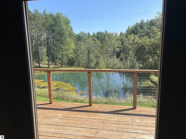 doorway featuring a water view and a view of trees