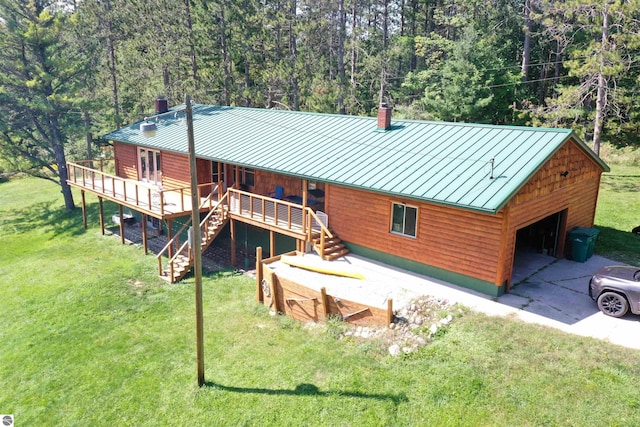 view of front of house featuring a standing seam roof, a chimney, a front lawn, and metal roof