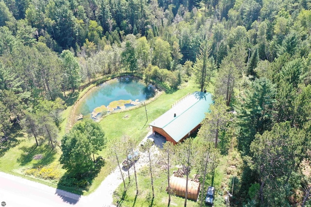 birds eye view of property with a water view and a view of trees