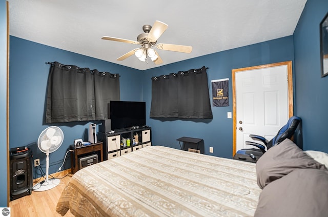 bedroom with ceiling fan and light hardwood / wood-style floors