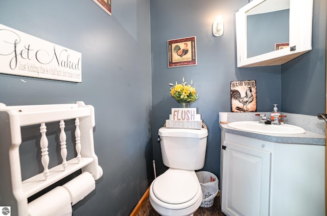 bathroom featuring toilet and vanity