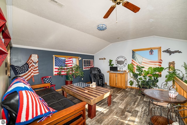 living room with vaulted ceiling, ornamental molding, hardwood / wood-style floors, and ceiling fan