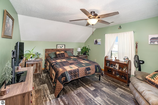 bedroom featuring lofted ceiling, ceiling fan, dark hardwood / wood-style flooring, and a textured ceiling