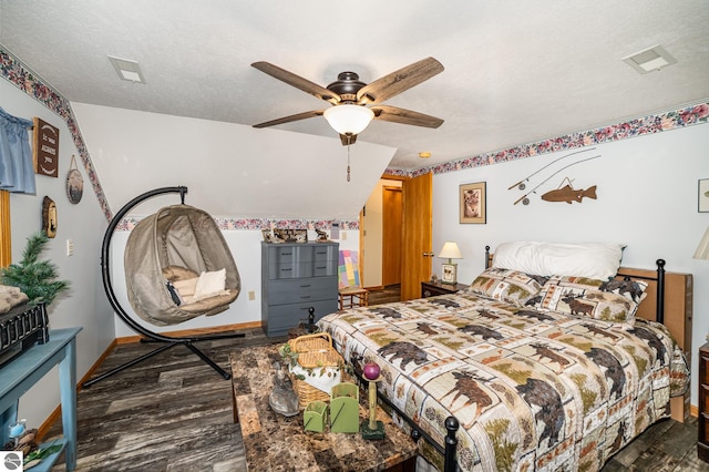 bedroom featuring ceiling fan, hardwood / wood-style flooring, and a textured ceiling