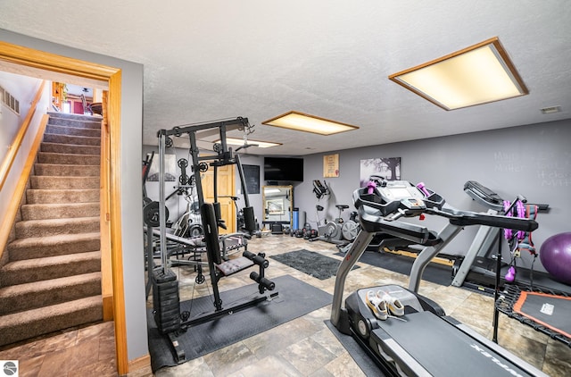 workout area featuring a textured ceiling