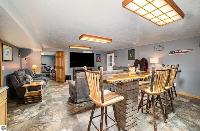 dining area featuring a textured ceiling