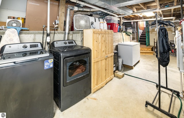 basement with washing machine and dryer and refrigerator