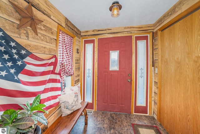 entryway with wood walls