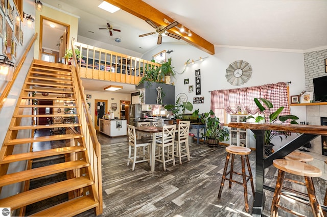 dining room featuring ceiling fan, ornamental molding, dark hardwood / wood-style flooring, and lofted ceiling with beams