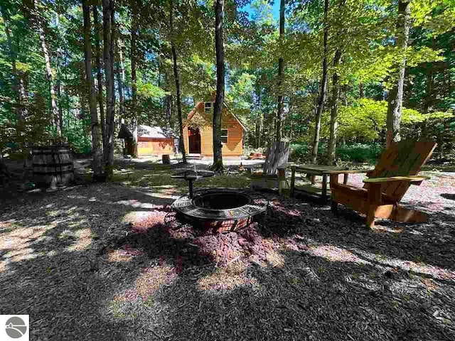 view of yard with an outdoor fire pit