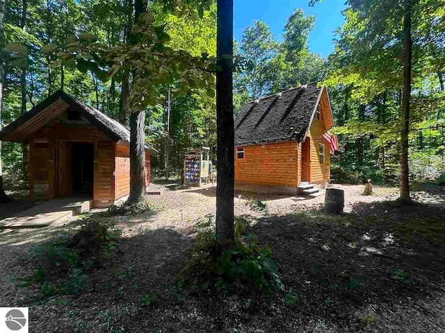 view of side of property featuring an outbuilding