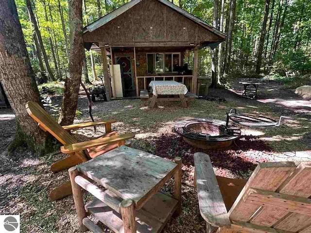 exterior space featuring an outdoor fire pit