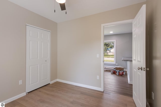 interior space featuring light hardwood / wood-style flooring, ceiling fan, and a closet