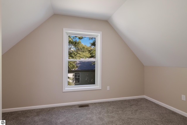 bonus room featuring lofted ceiling and carpet