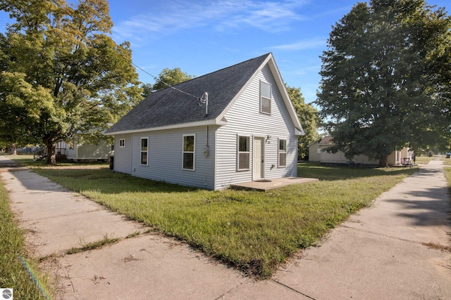 view of side of home with a lawn