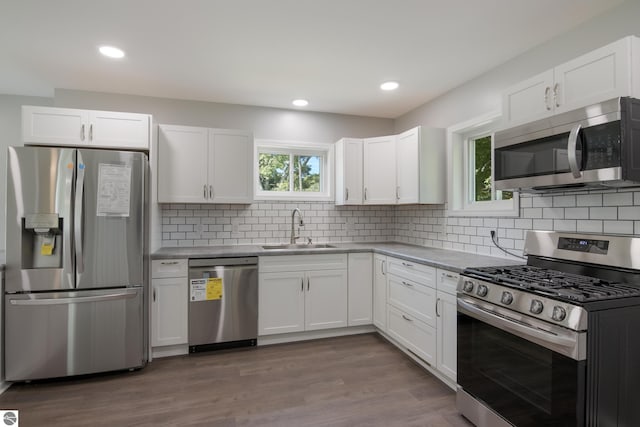 kitchen featuring sink, appliances with stainless steel finishes, and white cabinets