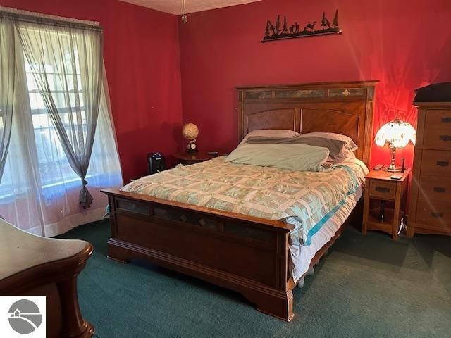 bedroom with dark colored carpet