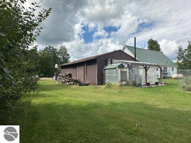 view of home's exterior featuring an outbuilding and a lawn