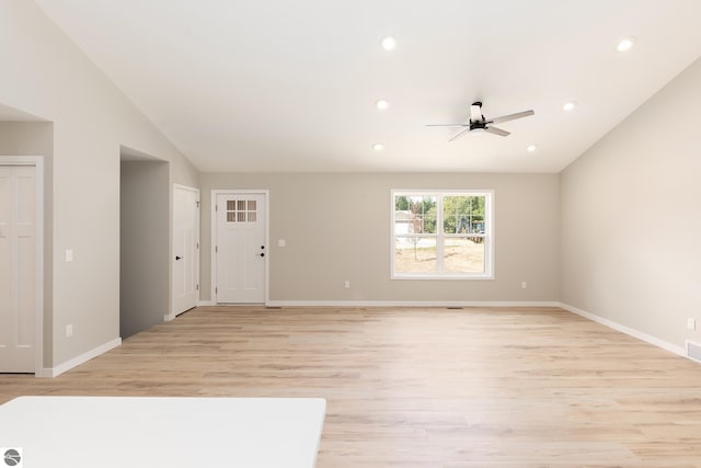 unfurnished living room featuring lofted ceiling, light wood-style flooring, baseboards, and recessed lighting