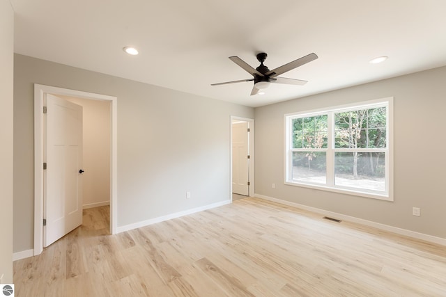 unfurnished room with light wood-type flooring, baseboards, and recessed lighting