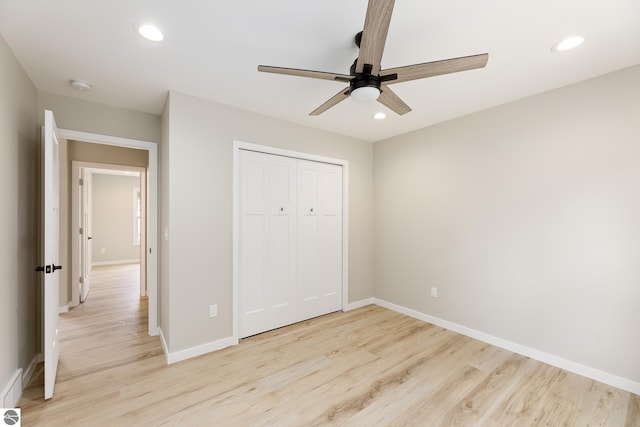 unfurnished bedroom with light wood-style floors, baseboards, a closet, and recessed lighting