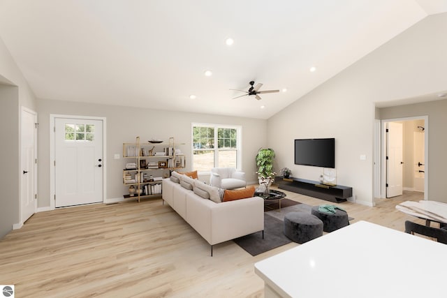 living room with lofted ceiling, ceiling fan, recessed lighting, baseboards, and light wood finished floors