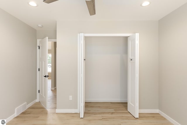 unfurnished bedroom with light wood-type flooring, a closet, visible vents, and recessed lighting