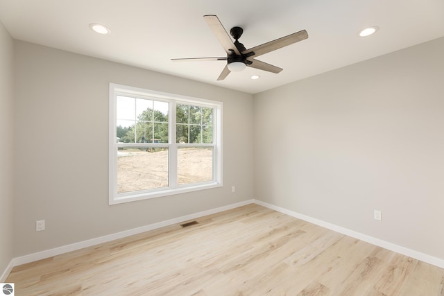 unfurnished room with recessed lighting, visible vents, light wood finished floors, and baseboards