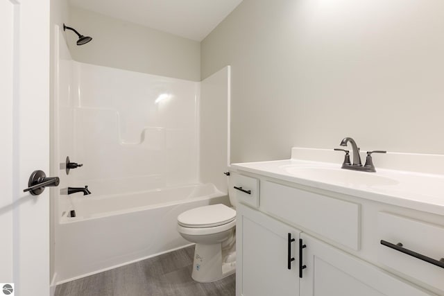 full bathroom with shower / tub combination, vanity, toilet, and wood finished floors