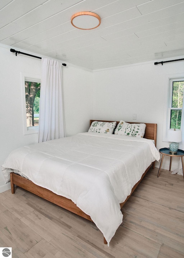 bedroom featuring wood ceiling and hardwood / wood-style floors