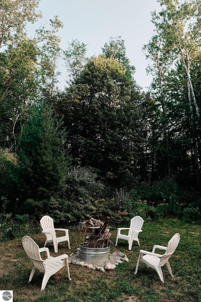 view of yard with a fire pit