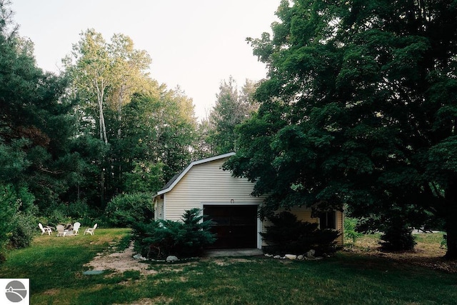 view of home's exterior with a garage and a yard