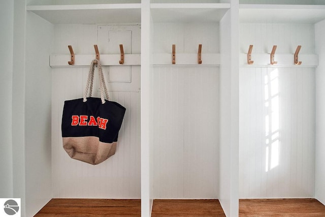 mudroom with wooden walls and hardwood / wood-style flooring