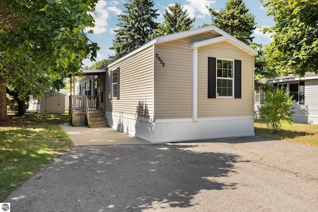 view of front of home featuring a storage shed