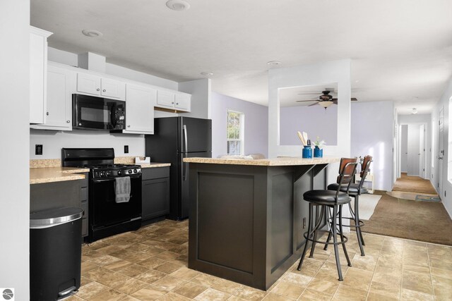 spare room with dark colored carpet and ceiling fan