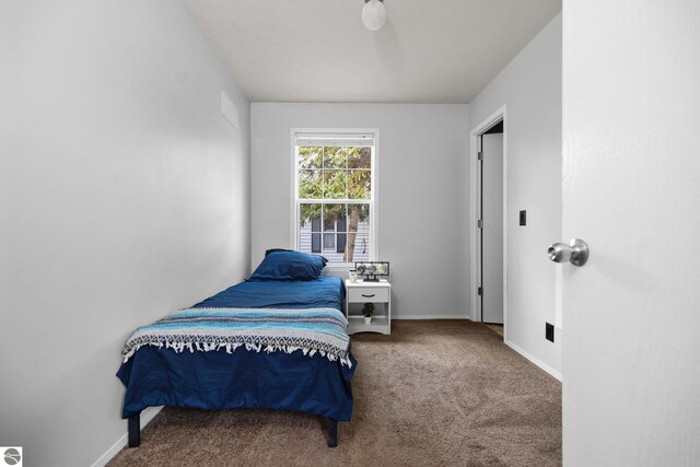 unfurnished room with a healthy amount of sunlight and dark carpet