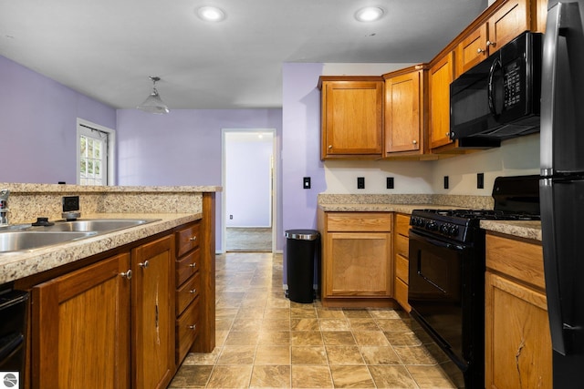 kitchen featuring pendant lighting, sink, and black appliances