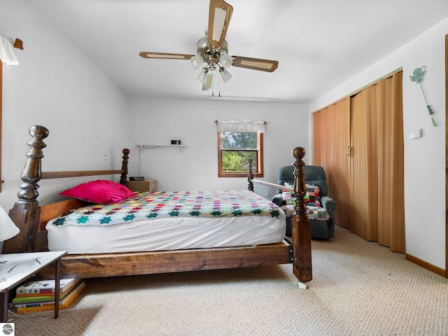 carpeted bedroom featuring ceiling fan and a closet