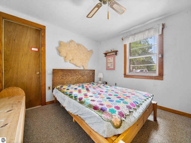 bedroom with ceiling fan and dark colored carpet