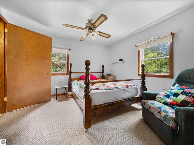 bedroom featuring carpet flooring, multiple windows, and ceiling fan