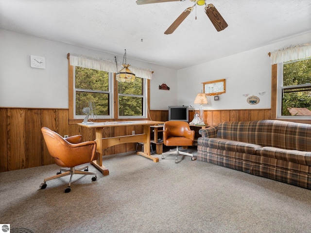 living room with ceiling fan, carpet floors, a textured ceiling, and a healthy amount of sunlight