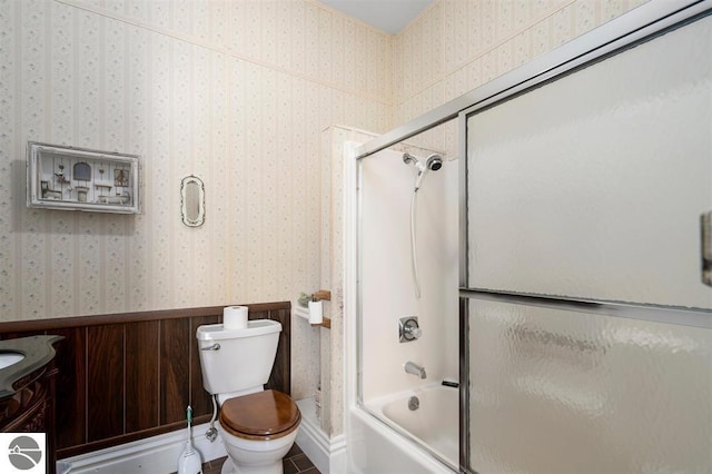 full bathroom with vanity, toilet, and bath / shower combo with glass door