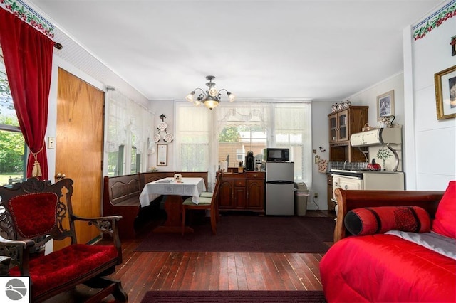 bedroom featuring crown molding, multiple windows, an inviting chandelier, and dark wood-type flooring